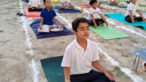 Students performing yoga at BOMIS Pampore